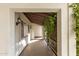 Covered walkway with tile flooring and lush greenery at 3126 E Monte Vista Rd, Phoenix, AZ 85008