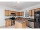 Bright kitchen featuring wood cabinets, an island, and modern appliances at 3126 E Monte Vista Rd, Phoenix, AZ 85008