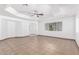 Spacious living room with tile floors and a ceiling fan at 3126 E Monte Vista Rd, Phoenix, AZ 85008
