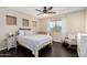 Spacious bedroom with a queen bed and rocking chair at 3206 S 256Th Dr, Buckeye, AZ 85326