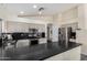 Modern kitchen with dark granite counters and stainless steel appliances at 3206 S 256Th Dr, Buckeye, AZ 85326