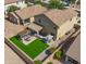 Aerial view showcasing a well-maintained backyard, covered patio, pergola, and lush landscaping at 3462 E Riopelle Ave, Gilbert, AZ 85298