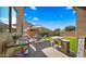 A bright backyard featuring artificial grass, patio, perimeter brick walls, and outdoor furniture at 3462 E Riopelle Ave, Gilbert, AZ 85298
