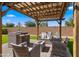 Outdoor seating area with comfortable seating, a fire pit, and a pergola with string lights at 3462 E Riopelle Ave, Gilbert, AZ 85298