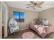 Small bedroom with daybed and ceiling fan at 3462 E Riopelle Ave, Gilbert, AZ 85298