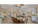 Bright dining area features a rustic wood table set, flowing into the living room and kitchen for open-concept living at 3462 E Riopelle Ave, Gilbert, AZ 85298