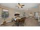 Open dining area featuring a decorative ceiling fan and views into the inviting living room, ideal for gatherings and meals at 3462 E Riopelle Ave, Gilbert, AZ 85298
