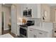 Bright kitchen featuring stainless steel appliances and white cabinetry with quartz countertops at 3462 E Riopelle Ave, Gilbert, AZ 85298