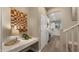 View of kitchen from hallway, white cabinets, and modern appliances at 3462 E Riopelle Ave, Gilbert, AZ 85298