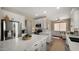 Modern kitchen with white cabinetry, stainless steel appliances, and a quartz island perfect for entertaining and everyday living at 3462 E Riopelle Ave, Gilbert, AZ 85298