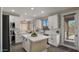 Modern kitchen boasts a convenient island, stainless steel appliances, and backyard access for seamless indoor-outdoor living at 3462 E Riopelle Ave, Gilbert, AZ 85298