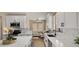 Charming kitchen with island, sleek appliances, and ample cabinet space, enhanced by natural light and backyard views at 3462 E Riopelle Ave, Gilbert, AZ 85298