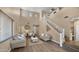 Spacious living room with vaulted ceilings, modern staircase and wood-look floors at 3462 E Riopelle Ave, Gilbert, AZ 85298