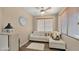 Cozy seating area with comfortable sofa, natural light, and neutral decor with wood-look floors at 3462 E Riopelle Ave, Gilbert, AZ 85298