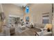 Bright and airy living room with tall ceilings and a ceiling fan, and a cozy sofa, creating a welcoming atmosphere at 3462 E Riopelle Ave, Gilbert, AZ 85298