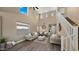 Bright, spacious living room with tall ceilings, neutral décor, and an abundance of natural light at 3462 E Riopelle Ave, Gilbert, AZ 85298