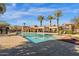 Community pool with surrounding patio and palm trees at 3801 E Orchid Ln, Phoenix, AZ 85044