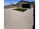Large backyard featuring gravel and a patch of green turf, perfect for outdoor activities at 38133 W Vera Cruz Dr, Maricopa, AZ 85138