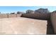 View of the expansive backyard enclosed by a tall block wall at 38133 W Vera Cruz Dr, Maricopa, AZ 85138