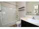 Clean bathroom with shower-tub combo, dark vanity, and wood-look floors at 38133 W Vera Cruz Dr, Maricopa, AZ 85138