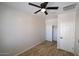 Cozy bedroom featuring wood-look floors, a ceiling fan, and a closet at 38133 W Vera Cruz Dr, Maricopa, AZ 85138