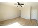 Spacious bedroom with a ceiling fan and modern wood-look tile flooring at 38133 W Vera Cruz Dr, Maricopa, AZ 85138