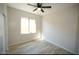 Bright bedroom with wood-look floors, a window with natural light, and neutral paint at 38133 W Vera Cruz Dr, Maricopa, AZ 85138