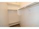 Walk-in closet with built-in shelves and metal hanging rods at 38133 W Vera Cruz Dr, Maricopa, AZ 85138