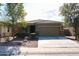 Single-story home with a two-car garage and desert landscaping at 38133 W Vera Cruz Dr, Maricopa, AZ 85138