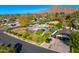 Aerial view of a home with a pool and landscaped yard near mountains at 3817 N Jokake Dr, Scottsdale, AZ 85251