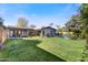 Expansive backyard featuring a sparkling pool and grassy area at 3817 N Jokake Dr, Scottsdale, AZ 85251