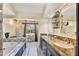 Elegant bathroom with granite countertops, double sinks, and a soaking tub at 3817 N Jokake Dr, Scottsdale, AZ 85251