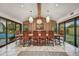 Spacious dining room with a large table, pool view, and access to the backyard through sliding glass doors at 3817 N Jokake Dr, Scottsdale, AZ 85251