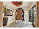 Grand entryway with arched wood door and tile flooring at 3817 N Jokake Dr, Scottsdale, AZ 85251