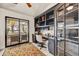 Home office with built-in bookcases, desk, and sliding glass doors leading to a patio at 3817 N Jokake Dr, Scottsdale, AZ 85251