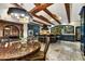 Spacious kitchen with dark cabinetry, large island, and exposed beams at 3817 N Jokake Dr, Scottsdale, AZ 85251