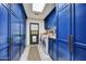 Bright laundry room with blue cabinetry and plenty of storage at 3817 N Jokake Dr, Scottsdale, AZ 85251