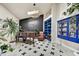 Cozy library with built-in bookshelves, piano, and leather armchair at 3817 N Jokake Dr, Scottsdale, AZ 85251