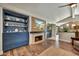 Spacious living room with hardwood floors, fireplace, built-in shelving and large TV at 3817 N Jokake Dr, Scottsdale, AZ 85251