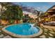 Stunning kidney-shaped pool surrounded by a stone patio at 3817 N Jokake Dr, Scottsdale, AZ 85251