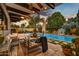 Inviting pool area with patio furniture and lush landscaping at 3817 N Jokake Dr, Scottsdale, AZ 85251