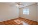 Light and airy bedroom with laminate wood flooring and ceiling fan at 4205 E Calypso Ave, Mesa, AZ 85206