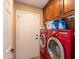 Laundry room with washer, dryer, and built-in cabinets at 4206 E Ellis Cir, Mesa, AZ 85205