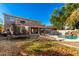 Large backyard with a pool, trampoline, and patio at 472 W Dragon Tree Ave, Queen Creek, AZ 85140