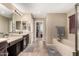 Elegant bathroom with double sinks, soaking tub, and walk-in shower at 472 W Dragon Tree Ave, Queen Creek, AZ 85140