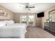King-size bedroom with private balcony access and large TV at 472 W Dragon Tree Ave, Queen Creek, AZ 85140