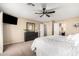 Spacious bedroom with large TV, dresser, and access to bathroom at 472 W Dragon Tree Ave, Queen Creek, AZ 85140