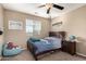 Well-lit bedroom with a full bed, nightstand and window seat at 472 W Dragon Tree Ave, Queen Creek, AZ 85140