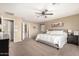 Large primary bedroom with plush carpet and private balcony access at 472 W Dragon Tree Ave, Queen Creek, AZ 85140