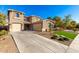 Two-story house with driveway, landscaping, and attached garage at 472 W Dragon Tree Ave, Queen Creek, AZ 85140